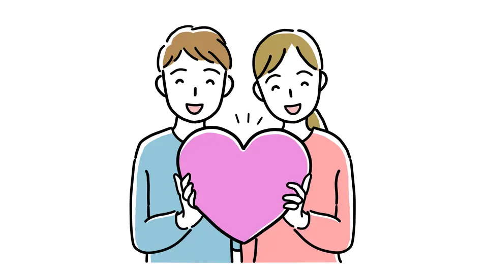 笑顔でハートを持つ若い男女カップル
