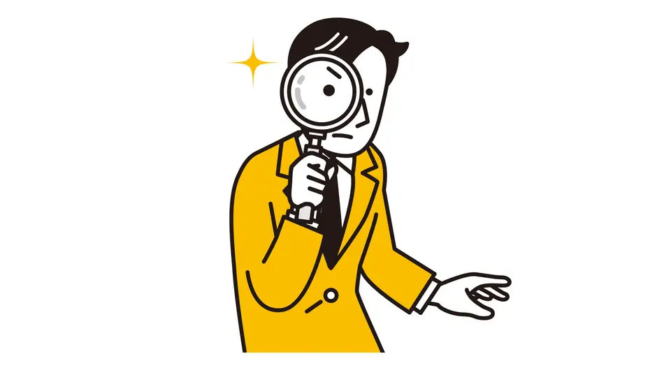 虫眼鏡を覗く男性
