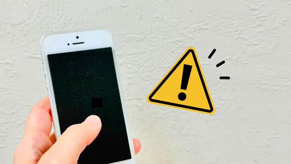 スマホを持つ手と警告マーク