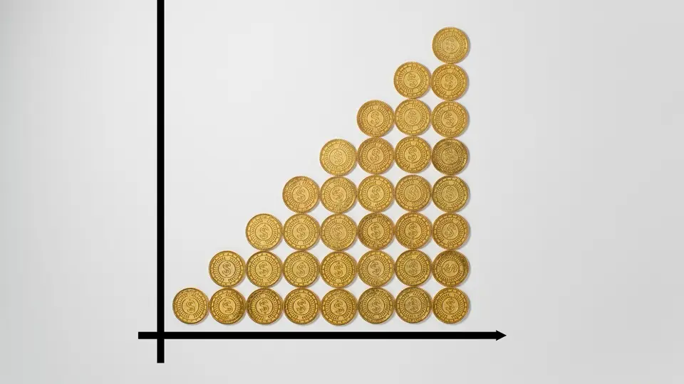 増えていく金貨のグラフと成長のイメージ
