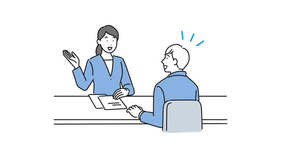 カウンターで相談する会社員男性 笑顔
