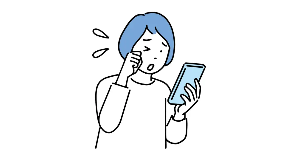 スマホの見過ぎで目が疲れた女性