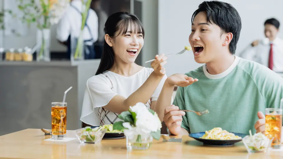 カフェで食事をする若いカップル